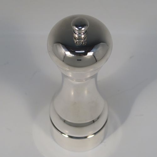 A large and handsome Sterling Silver pepper grinder, having a plain round baluster body, an original Peter Piper grinder mechanism, and a plain round finial. This elegant silver pepper grinder was made by W.E.V. of London in 1986. The dimensions of this fine hand-made silver pepper grinder are height 15 cms (6 inches), diameter at base 5 cms (2 inches), and it weighs approx. 185g (6 troy ounces).   
