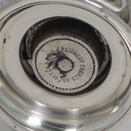 Antique Victorian sterling silver and hand-cut crystal pepper grinder, having a round body with hobnail-cut pattern, plain round mounts top and bottom, an opening for adding the pepper corns that is revealed by twisting the top mount, a side-winding grinder arm with ivory finial, and an original Peugeot grinding mechanism. Made in Birmingham in 1898. The dimensions of this fine hand-made silver and crystal pepper grinder are height 9 cms (3.5 inches), and diameter at base 6.5 cms (2.5 inches). 