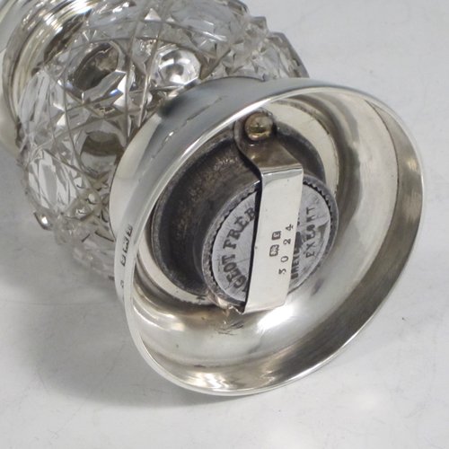 Antique Edwardian sterling silver and hand-cut crystal pepper grinder, having a round body with hobnail-cut pattern, plain round mounts top and bottom, and an original Peugeot grinding mechanism. Made John Grinsell of Birmingham in 1905. The dimensions of this fine hand-made silver and crystal pepper grinder are height 9 cms (3.5 inches), and diameter at base 6 cms (2.25 inches).