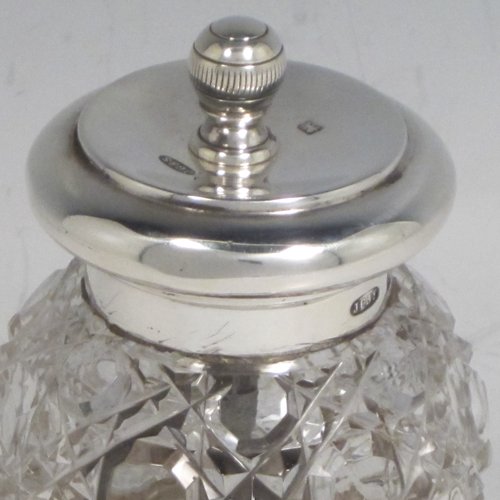 Antique Edwardian sterling silver and hand-cut crystal pepper grinder, having a round body with hobnail-cut pattern, plain round mounts top and bottom, and an original Peugeot grinding mechanism. Made John Grinsell of Birmingham in 1905. The dimensions of this fine hand-made silver and crystal pepper grinder are height 9 cms (3.5 inches), and diameter at base 6 cms (2.25 inches).