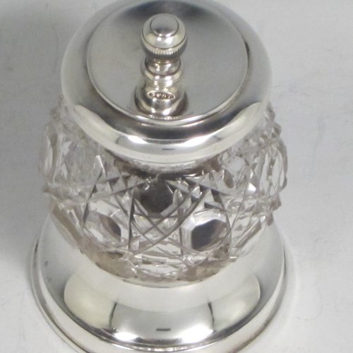 Antique Edwardian sterling silver and hand-cut crystal pepper grinder, having a round body with hobnail-cut pattern, plain round mounts top and bottom, and an original Peugeot grinding mechanism. Made John Grinsell of Birmingham in 1905. The dimensions of this fine hand-made silver and crystal pepper grinder are height 9 cms (3.5 inches), and diameter at base 6 cms (2.25 inches).