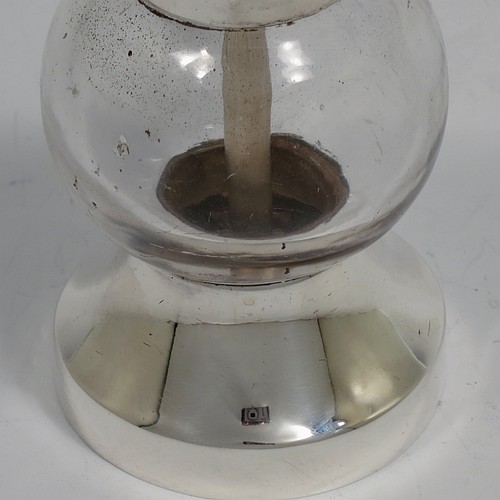 A handsome Antique Edwardian Sterling Silver and hand-blown crystal pepper grinder, having a plain round body with plain mounts top and bottom, a side-winding grinder arm with wooden finial, and an original Peugeot grinding mechanism. Made by Heath and Middleton of Birmingham in 1902. The dimensions of this fine hand-made antique silver and crystal pepper grinder are height 9.5 cms (3.75 inches), and diameter at base 5.5 cms (2.25 inches).    