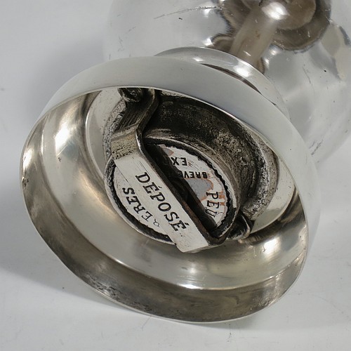 A handsome Antique Edwardian Sterling Silver and hand-blown crystal pepper grinder, having a plain round body with plain mounts top and bottom, a side-winding grinder arm with wooden finial, and an original Peugeot grinding mechanism. Made by Heath and Middleton of Birmingham in 1902. The dimensions of this fine hand-made antique silver and crystal pepper grinder are height 9.5 cms (3.75 inches), and diameter at base 5.5 cms (2.25 inches).    