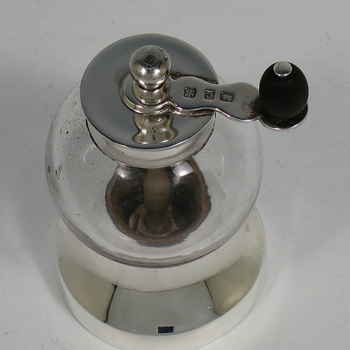 A handsome Antique Edwardian Sterling Silver and hand-blown crystal pepper grinder, having a plain round body with plain mounts top and bottom, a side-winding grinder arm with wooden finial, and an original Peugeot grinding mechanism. Made by Heath and Middleton of Birmingham in 1902. The dimensions of this fine hand-made antique silver and crystal pepper grinder are height 9.5 cms (3.75 inches), and diameter at base 5.5 cms (2.25 inches).    