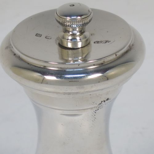 A very handsome pair of Antique Sterling Silver pepper grinders, having plain round baluster bodies, with original grinder mechanisms, and knurled finials. Made by John Grinsell and Sons of Birmingham in 1911. The dimensions of this fine pair of hand-made antique silver pepper grinders are height 8.5 cms (3.25 inches), diameter at bases 4.5 cms (1.75 inches), and they weigh approx. 186g (6 troy ounces).