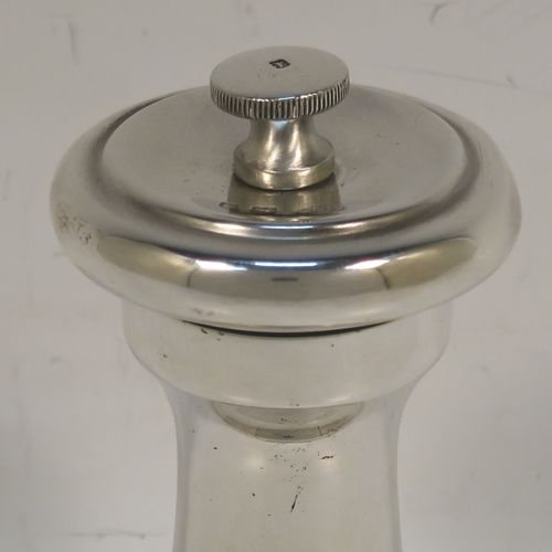 A handsome Sterling Silver pepper grinder, having a plain round baluster body, an original Peugeot grinder mechanism, and a knurled finial. This beautiful silver pepper grinder was made by Goldsmiths and Silversmiths of London in 1927. The dimensions of this fine hand-made silver pepper grinder are height 9 cms (3.5 inches), diameter at base 5 cms (2 inches), and it weighs approx. 96g (3 troy ounces).