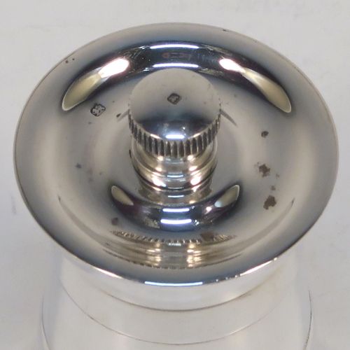 A very handsome Sterling Silver pepper grinder in a milk churn style, having a plain tapering straight sided body with three applied bands of decoration, with a knurled grinder finial, and a Peter Piper grinder mechanism. This elegant silver pepper grinder was made by Park Green and Co., of London in 1957. The dimensions of this fine hand-made silver pepper grinder are height 7.5 cms (3 inches), and diameter at base 4 cms (1.5 inches).