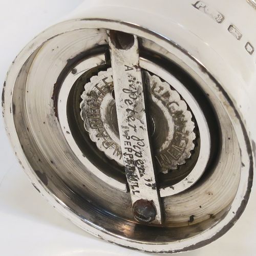 A very handsome Sterling Silver pepper grinder in a milk churn style, having a plain tapering straight sided body with three applied bands of decoration, with a knurled grinder finial, and a Peter Piper grinder mechanism. This elegant silver pepper grinder was made by Park Green and Co., of London in 1957. The dimensions of this fine hand-made silver pepper grinder are height 7.5 cms (3 inches), and diameter at base 4 cms (1.5 inches).