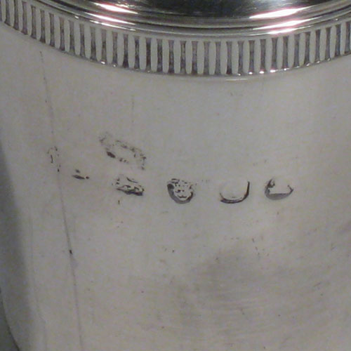 Antique Georgian sterling silver pepper pot (or possibly a pounce pot), having a plain round body with tapering sides, gadroon edge borders top and bottom, and a pull-off pierced lid with cast Cauliflower finial. Made by Michael Starkey of London in 1818. The dimensions of this fine hand-made silver pounce or pepper pot are height 8.5 cms (3.3 inches), diameter 4 cms (1.5 inches), and it weighs approx. 67g (2.2 troy ounces). Please note that this item is crested on one side with a Punch-like figure.