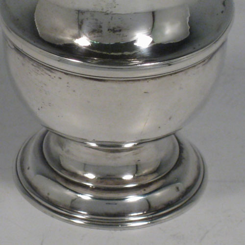 Antique Georgian sterling silver pepper pot, having a plain baluster body, a hand-pierced pull-off lid with finial, and sitting on a pedestal foot. Made by Thomas Bamford I of London in 1736. The dimensions of this fine hand-made silver pepper pot are height 13.5 cms (5.3 inches), diameter of main body 4.5 cms (1.75 inches), and it weighs approx. 101g (3.3 troy ounces).