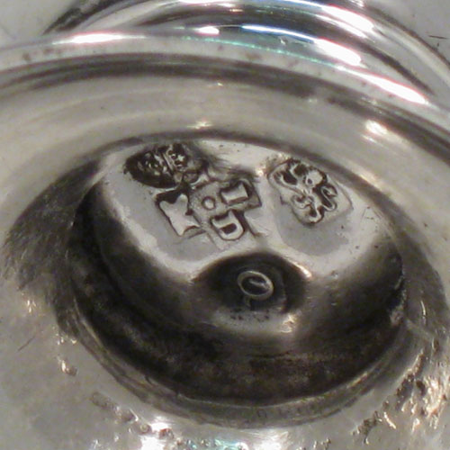 Antique Georgian sterling silver pepper pot, having a plain baluster body with a band of floral engraving and vacant laurel-leaf cartouche, a hand-pierced pull-off lid with swirl finial, and sitting on a pedestal foot with matching engraving. Made in London in 1771. The dimensions of this fine hand-made silver pepper pot are height 14 cms (5.5 inches), diameter of main body 5 cms (2 inches), and it weighs approx. 98g (3.2 troy ounces).