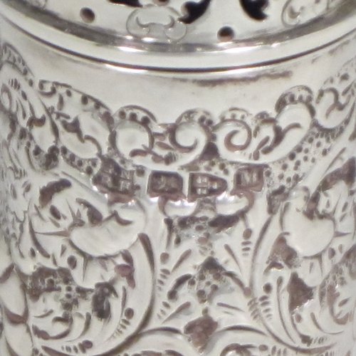 Antique Victorian sterling silver pepper pot (or small sugar caster), having a cylindrical body with hand-chased floral decoration, a hand-pierced pull-off lid, and sitting on a collet foot. Made by Nathan & Hayes of Chester in 1895. The dimensions of this fine hand-made silver caster / pepper pot are height 10 cms (4 inches), diameter at base main body 4 cms (1.5 inches), and it weighs approx. 85g (2.7 troy ounces)