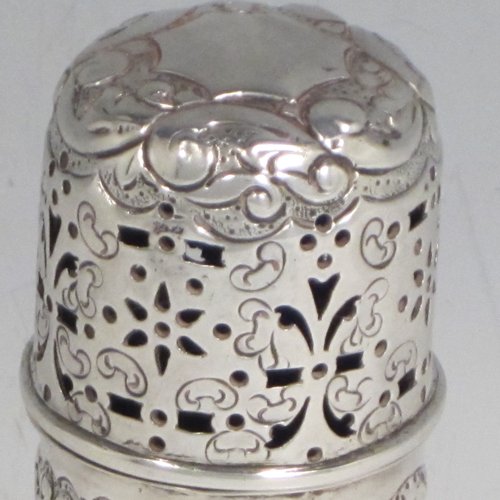 Antique Victorian sterling silver pepper pot (or small sugar caster), having a cylindrical body with hand-chased floral decoration, a hand-pierced pull-off lid, and sitting on a collet foot. Made by Nathan & Hayes of Chester in 1895. The dimensions of this fine hand-made silver caster / pepper pot are height 10 cms (4 inches), diameter at base main body 4 cms (1.5 inches), and it weighs approx. 85g (2.7 troy ounces)
