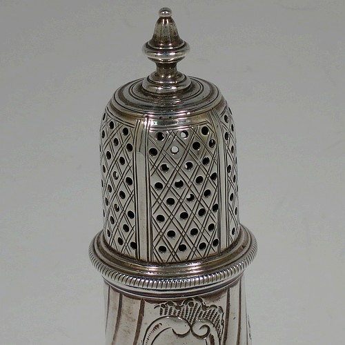A very handsome Antique Georgian George III Sterling Silver pepper pot, having a baluster body with hand-chased fluted and floral decoration, applied rope-twist borders, a hand-pierced pull-off lid with urn finial, and sitting on a pedestal foot. Made by William Turton of London in 1777. The dimensions of this fine hand-made antique silver pepper pot are height 15 cms (6 inches), diameter of main body 6 cms (2.25 inches), and it weighs approx. 142g (4.6 troy ounces).
