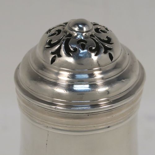A very handsome Antique Georgian George I Britannia standard silver Bun style pepper pot, having a plain round bellied body, with applied reeded borders, a pull-off pierced lid, and sitting on a pedestal foot. This elegant antique Georgian silver bun pepper was made by George Greenhill Jones London in 1723. The dimensions of this fine hand-made Britannia standard silver pepper pot are height 11 cms (4.25 inches), diameter of main body 5 cms (2 inches), and it weighs approx. 110g (3.5 troy ounces).