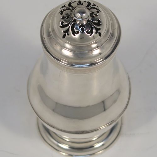 A very handsome Antique Georgian George I Britannia standard silver Bun style pepper pot, having a plain round bellied body, with applied reeded borders, a pull-off pierced lid, and sitting on a pedestal foot. This elegant antique Georgian silver bun pepper was made by George Greenhill Jones London in 1723. The dimensions of this fine hand-made Britannia standard silver pepper pot are height 11 cms (4.25 inches), diameter of main body 5 cms (2 inches), and it weighs approx. 110g (3.5 troy ounces).