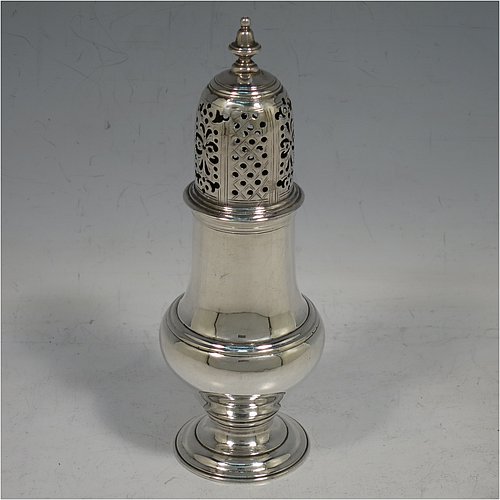 An Antique Georgian George II Sterling Silver pepper pot, having a plain baluster body with applied reeded borders, a hand-pierced pull-off lid with urn-shaped finial, and sitting on a pedestal foot. Made by Samuel Woods of London in 1758. The dimensions of this fine hand-made antique silver pepper pot are height 15 cms (6 inches), diameter of main body 5 cms (2 inches), and it weighs approx. 131g (4.2 troy ounces).   
