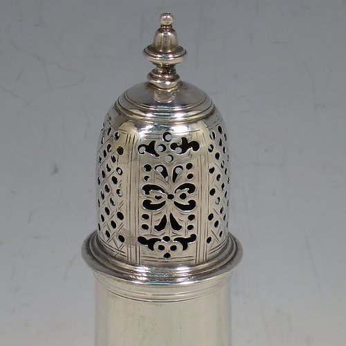 An Antique Georgian George II Sterling Silver pepper pot, having a plain baluster body with applied reeded borders, a hand-pierced pull-off lid with urn-shaped finial, and sitting on a pedestal foot. Made by Samuel Woods of London in 1758. The dimensions of this fine hand-made antique silver pepper pot are height 15 cms (6 inches), diameter of main body 5 cms (2 inches), and it weighs approx. 131g (4.2 troy ounces).