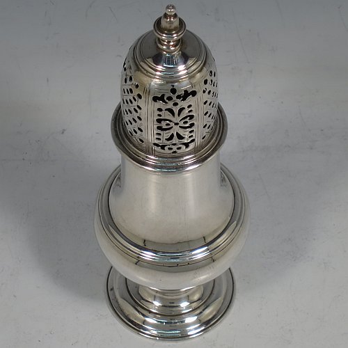 An Antique Georgian George II Sterling Silver pepper pot, having a plain baluster body with applied reeded borders, a hand-pierced pull-off lid with urn-shaped finial, and sitting on a pedestal foot. Made by Samuel Woods of London in 1758. The dimensions of this fine hand-made antique silver pepper pot are height 15 cms (6 inches), diameter of main body 5 cms (2 inches), and it weighs approx. 131g (4.2 troy ounces).