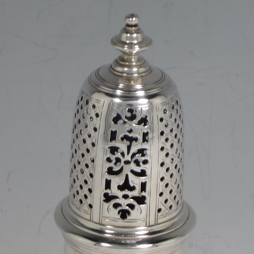 An Antique Georgian sterling silver pair of George II pepper pots, having plain round baluster bodies, with hand-pierced pull-off lids and finials, and sitting on pedestal feet. Made by Thomas Bamford I of London in 1730. The dimensions of these fine hand-made silver pepper pots are height 14.5 cms (5.75 inches), diameter of main body 5 cms (2 inches), and they weigh a total of approx. 257g (8.3 troy ounces).