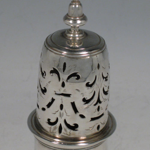 Antique Georgian sterling silver pepper pot, having a plain baluster body, a hand-pierced pull-off lid with finial, and sitting on a pedestal foot. Made by Thomas Rush of London in 1724. The dimensions of this fine hand-made silver pepper pot are height 14.5 cms (5.75 inches), diameter of main body 6 cms (2.25 inches), and it weighs approx. 131g (4.2 troy ounces).