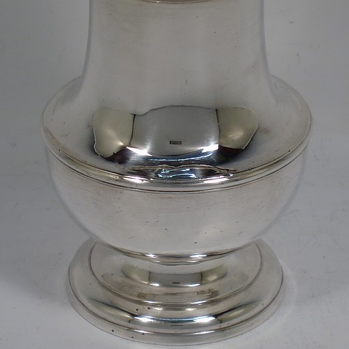 A very handsome Antique Georgian George I Sterling Silver heavy pepper pot caster, having a plain bellied body with applied and hand-chased reeded borders, a pull-off hand-pierced lid with cast finial, all sitting on a stepped pedestal foot. Made by Samuel Welder of London in 1725. The dimensions of this fine hand-made antique silver pepper caster pot are height 16 cms (6.25 inches), width 6.5 cms (2.5 inches), and it weighs approx. 185g (6 troy ounces).
