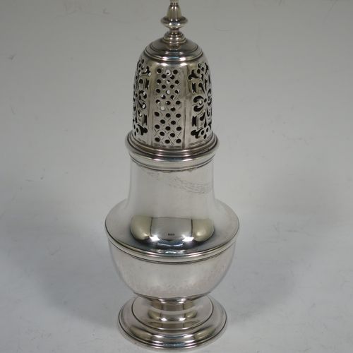 A very handsome Antique Georgian George II Sterling Silver pepper pot, having a plain baluster body with applied reeded borders, a hand-pierced pull-off lid with urn-shaped finial, and sitting on a pedestal foot. Made by Samuel Woods of London in 1749. The dimensions of this fine hand-made antique silver pepper pot are height 16 cms (6.25 inches), diameter of main body 6 cms (2.3 inches), and it weighs approx. 158g (5 troy ounces).    