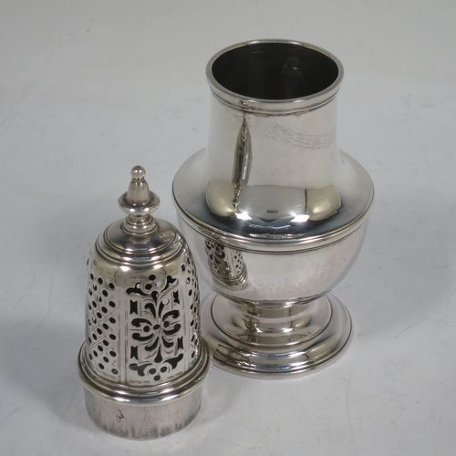 A very handsome Antique Georgian George II Sterling Silver pepper pot, having a plain baluster body with applied reeded borders, a hand-pierced pull-off lid with urn-shaped finial, and sitting on a pedestal foot. Made by Samuel Woods of London in 1749. The dimensions of this fine hand-made antique silver pepper pot are height 16 cms (6.25 inches), diameter of main body 6 cms (2.3 inches), and it weighs approx. 158g (5 troy ounces).