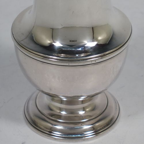 A very handsome Antique Georgian George II Sterling Silver pepper pot, having a plain baluster body with applied reeded borders, a hand-pierced pull-off lid with urn-shaped finial, and sitting on a pedestal foot. Made by Samuel Woods of London in 1749. The dimensions of this fine hand-made antique silver pepper pot are height 16 cms (6.25 inches), diameter of main body 6 cms (2.3 inches), and it weighs approx. 158g (5 troy ounces).