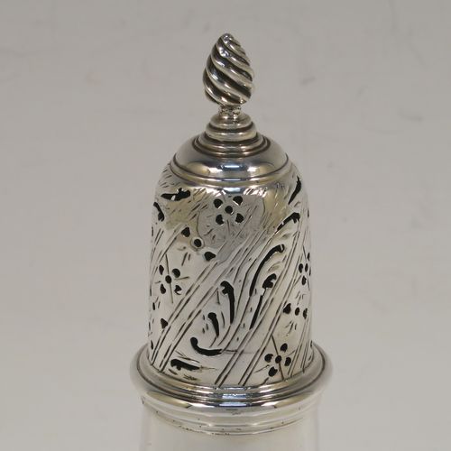 A handsome Antique Georgian Sterling Silver pepper pot, having a plain round bellied body, a hand-pierced pull-off lid with swirl finial, and sitting on a pedestal foot. This elegant antique silver pepper pot was made by John Delmester of London in 1764. The dimensions of this fine hand-made silver pepper pot are height 15 cms (6 inches), diameter of main body 5 cms (2 inches), and it weighs approx. 150g (4.8 troy ounces).