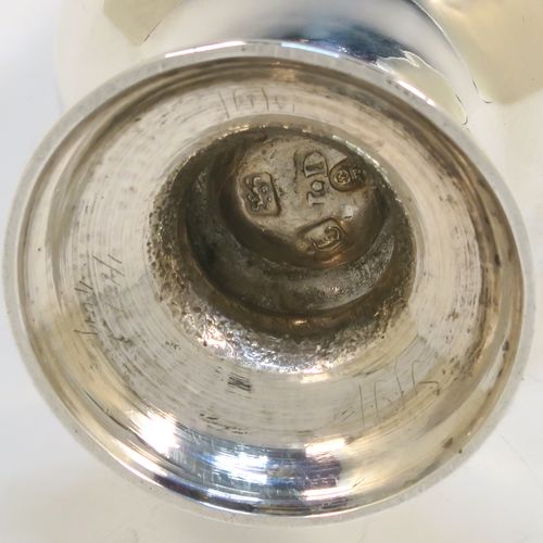 A handsome Antique Georgian Sterling Silver pepper pot, having a plain round bellied body, a hand-pierced pull-off lid with swirl finial, and sitting on a pedestal foot. This elegant antique silver pepper pot was made by John Delmester of London in 1764. The dimensions of this fine hand-made silver pepper pot are height 15 cms (6 inches), diameter of main body 5 cms (2 inches), and it weighs approx. 150g (4.8 troy ounces).