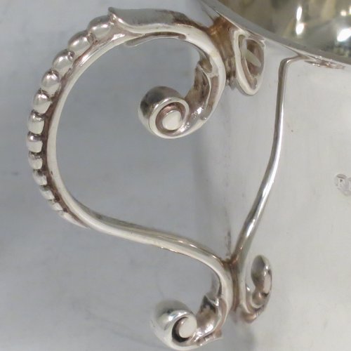 An Antique Victorian Sterling Silver porringer, having a plain round baluster body, two scroll side handles with beaded decoration, and sitting on a flat base. Made by Francis Higgins of London in 1897. The dimensions of this fine hand-made antique silver porringer are height 7.5 cms (3 inches), spread across arms 14 cms (5.5 inches), and it weighs approx. 163g (5.3 troy ounces).