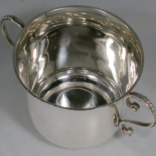 An Antique Victorian Sterling Silver porringer, having a plain round baluster body, two scroll side handles with beaded decoration, and sitting on a flat base. Made by Francis Higgins of London in 1897. The dimensions of this fine hand-made antique silver porringer are height 7.5 cms (3 inches), spread across arms 14 cms (5.5 inches), and it weighs approx. 163g (5.3 troy ounces).