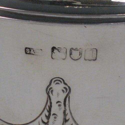 Antique Edwardian sterling silver hand-chased porringer with cast figural handles, cast floral finial, and floral hand-chasing. Made by Skinner and Co., of London in 1904. Height 19 cms (7.5 inches), spread across arms 24 cms (9.5 inches). Weight approx. 777g (25 troy ounces).