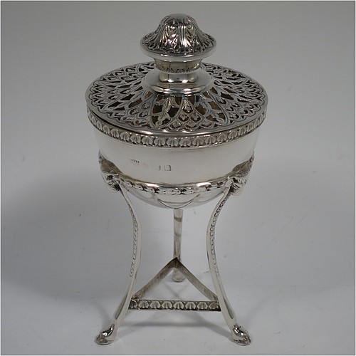 A Sterling Silver pot pourri holder, having a round bellied body sitting in a cast three-legged frame, with hoof feet, applied cast rams heads and floral borders, a pull-off lid with hand-engraved and pierced decoration surrounding a round knop handle. Made by S. Blanckensee and Sons of Birmingham in 1924. The dimensions of this fine hand-made silver pot-pourri holder are height 14 cms (5.5 inches), diameter 7 cms (2.75 inches), and it weighs approx. 147g (4.7 troy ounces).    