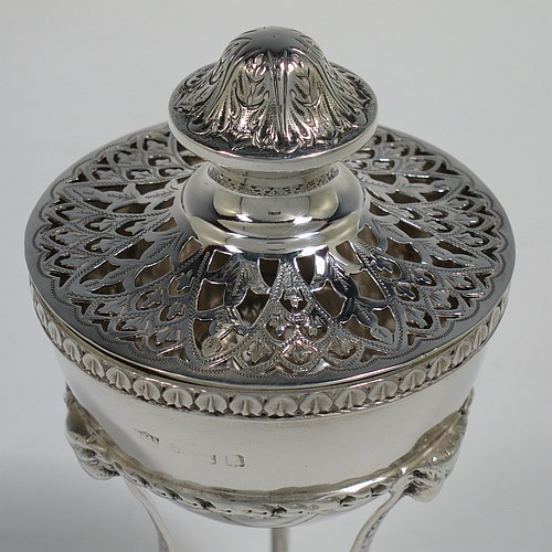 A Sterling Silver pot pourri holder, having a round bellied body sitting in a cast three-legged frame, with hoof feet, applied cast rams heads and floral borders, a pull-off lid with hand-engraved and pierced decoration surrounding a round knop handle. Made by S. Blanckensee and Sons of Birmingham in 1924. The dimensions of this fine hand-made silver pot-pourri holder are height 14 cms (5.5 inches), diameter 7 cms (2.75 inches), and it weighs approx. 147g (4.7 troy ounces).