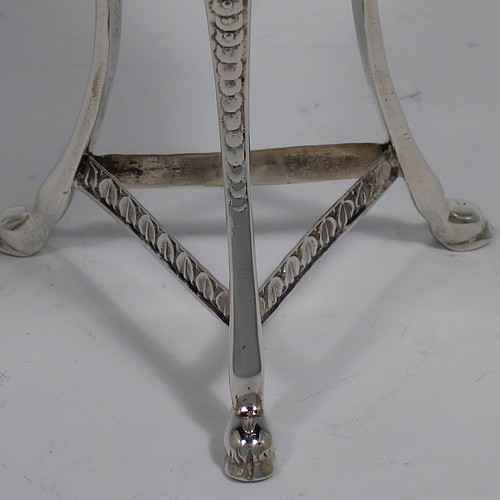 A Sterling Silver pot pourri holder, having a round bellied body sitting in a cast three-legged frame, with hoof feet, applied cast rams heads and floral borders, a pull-off lid with hand-engraved and pierced decoration surrounding a round knop handle. Made by S. Blanckensee and Sons of Birmingham in 1924. The dimensions of this fine hand-made silver pot-pourri holder are height 14 cms (5.5 inches), diameter 7 cms (2.75 inches), and it weighs approx. 147g (4.7 troy ounces).