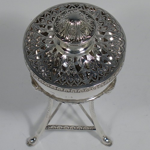 A Sterling Silver pot pourri holder, having a round bellied body sitting in a cast three-legged frame, with hoof feet, applied cast rams heads and floral borders, a pull-off lid with hand-engraved and pierced decoration surrounding a round knop handle. Made by S. Blanckensee and Sons of Birmingham in 1924. The dimensions of this fine hand-made silver pot-pourri holder are height 14 cms (5.5 inches), diameter 7 cms (2.75 inches), and it weighs approx. 147g (4.7 troy ounces).