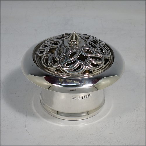 An Antique Edwardian Sterling Silver pot pourri holder, having a plain round body with tapering sides, a pull-off pierced grill with cast finial, a gold-gilt interior, and all sitting on a flat base. Made by Samuel Jacob of London in 1907. The dimensions of this fine hand-made antique silver pot-pourri holder are diameter 8 cms (3.25 inches), height 7 cms (2.75 inches), and it weighs approx. 86g (2.8 troy ounces).    