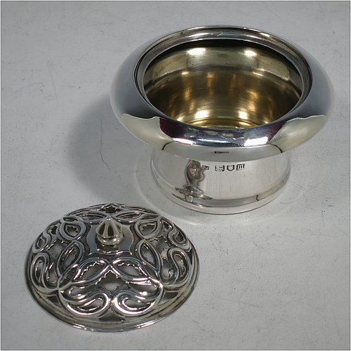 An Antique Edwardian Sterling Silver pot pourri holder, having a plain round body with tapering sides, a pull-off pierced grill with cast finial, a gold-gilt interior, and all sitting on a flat base. Made by Samuel Jacob of London in 1907. The dimensions of this fine hand-made antique silver pot-pourri holder are diameter 8 cms (3.25 inches), height 7 cms (2.75 inches), and it weighs approx. 86g (2.8 troy ounces).