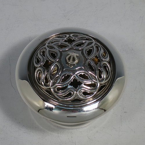 An Antique Edwardian Sterling Silver pot pourri holder, having a plain round body with tapering sides, a pull-off pierced grill with cast finial, a gold-gilt interior, and all sitting on a flat base. Made by Samuel Jacob of London in 1907. The dimensions of this fine hand-made antique silver pot-pourri holder are diameter 8 cms (3.25 inches), height 7 cms (2.75 inches), and it weighs approx. 86g (2.8 troy ounces).