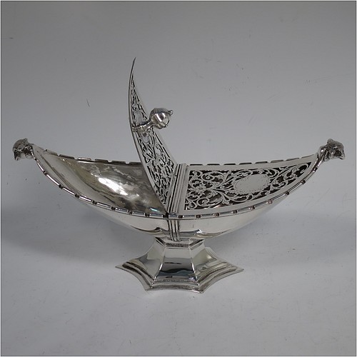 A very pretty Antique Sterling Silver pot pourri holder, or ecclesiastical Thurible incense burner, having an unusual boat-shaped body with a hand-pierced floral style cover, with one side hinged with a cast octagonal ball finial, two cast lambs-head side-handles, and all sitting on a spreading hexafoil pedestal foot. Made by Nathan and Hayes of Chester in 1912. The dimensions of this fine hand-made antique silver pot-pourri holder, or ecclesiastical Thurible incense burner, are length 19 cms (7.5 inches), width 6.5 cms (2.5 inches), height 8 cms (3 inches), and it weighs approx. 195g (6.3 troy ounces)
