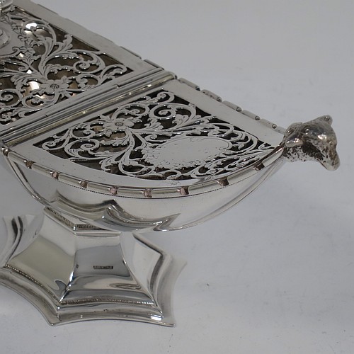 A very pretty Antique Sterling Silver pot pourri holder, or ecclesiastical Thurible incense burner, having an unusual boat-shaped body with a hand-pierced floral style cover, with one side hinged with a cast octagonal ball finial, two cast lambs-head side-handles, and all sitting on a spreading hexafoil pedestal foot. Made by Nathan and Hayes of Chester in 1912. The dimensions of this fine hand-made antique silver pot-pourri holder, or ecclesiastical Thurible incense burner, are length 19 cms (7.5 inches), width 6.5 cms (2.5 inches), height 8 cms (3 inches), and it weighs approx. 195g (6.3 troy ounces)