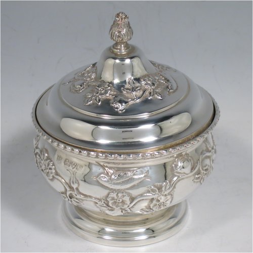 An Antique Edwardian Sterling Silver pot pourri holder, having a round bellied hand-body body with bird and floral decoration, a hinged lid with cast floral finial, and an internal pull-off pierced grill with ball finial, all sitting on a pedestal foot. Made by Nathan & Hayes of Chester in 1909. The dimensions of this fine hand-made antique silver pot-pourri holder are diameter 9 cms (3.5 inches), height 11 cms (4.3 inches), and it weighs approx. 157g (6 troy ounces).   
