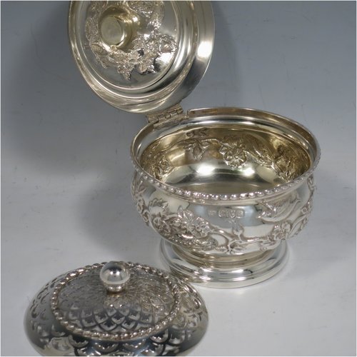 An Antique Edwardian Sterling Silver pot pourri holder, having a round bellied hand-body body with bird and floral decoration, a hinged lid with cast floral finial, and an internal pull-off pierced grill with ball finial, all sitting on a pedestal foot. Made by Nathan & Hayes of Chester in 1909. The dimensions of this fine hand-made antique silver pot-pourri holder are diameter 9 cms (3.5 inches), height 11 cms (4.3 inches), and it weighs approx. 157g (6 troy ounces).