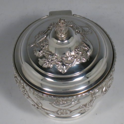 An Antique Edwardian Sterling Silver pot pourri holder, having a round bellied hand-body body with bird and floral decoration, a hinged lid with cast floral finial, and an internal pull-off pierced grill with ball finial, all sitting on a pedestal foot. Made by Nathan & Hayes of Chester in 1909. The dimensions of this fine hand-made antique silver pot-pourri holder are diameter 9 cms (3.5 inches), height 11 cms (4.3 inches), and it weighs approx. 157g (6 troy ounces).
