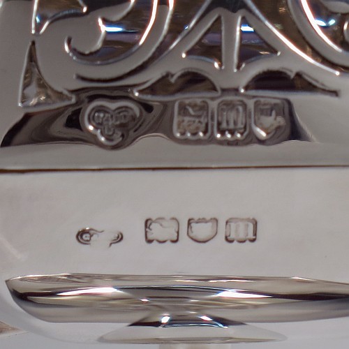 A very handsome and large Antique Edwardian Sterling Silver pot pourri holder in an Art Nouveau style, having an unusual trophy shaped body with two-side-handles, a lift off hand-pierced and panelled lid with cast urn-shaped finial, and all sitting on an octagonal pedestal foot. Made by Goldsmiths and Silversmiths of London in 1907. The dimensions of this fine hand-made antique silver pot-pourri holder are height 28 cms (11 inches), spread across arms 18.5 cms (7.25 inches), and it weighs approx. 482g (15.5 troy ounces)