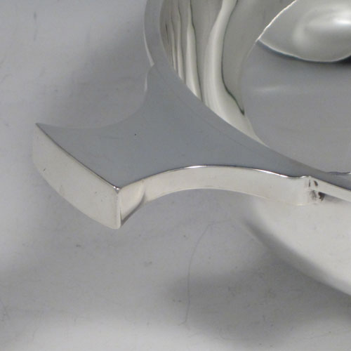 Antique Sterling Silver large Quaich, having a very plain round body, with two traditional handles, and sitting on a collet foot. This beautiful sterling silver quaich was made by Martin and Hall of Sheffield in 1911. The dimensions of this fine hand-made silver quaich are diameter 17.5 cms (7 inches), height 6 cms (2.25 inches), and it weighs approx. 371g (12 troy ounces).