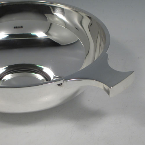 Antique Sterling Silver large Quaich, having a very plain round body, with two traditional handles, and sitting on a collet foot. This beautiful sterling silver quaich was made by Martin and Hall of Sheffield in 1911. The dimensions of this fine hand-made silver quaich are diameter 17.5 cms (7 inches), height 6 cms (2.25 inches), and it weighs approx. 371g (12 troy ounces).