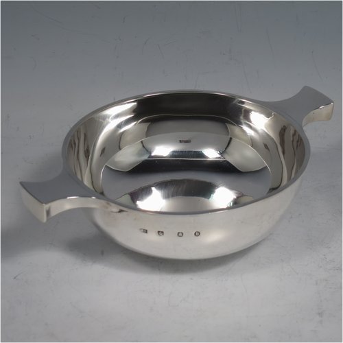 An Antique Victorian Sterling silver Scottish quaich, having a very plain round body, with two side handles, sitting on a collet foot. Made by Brook & Son of Edinburgh in 1889. The dimensions of this fine hand-made antique silver quaich are diameter of body 11 cms (4.25 inches), height 4 cms (1.5 inches), and it weighs approx. 145g (4.7 troy ounces).   